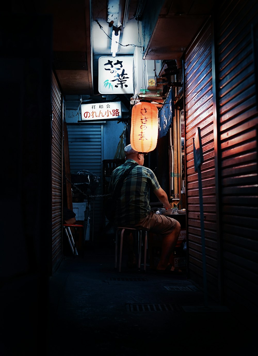 a man sitting at a table in a dark room