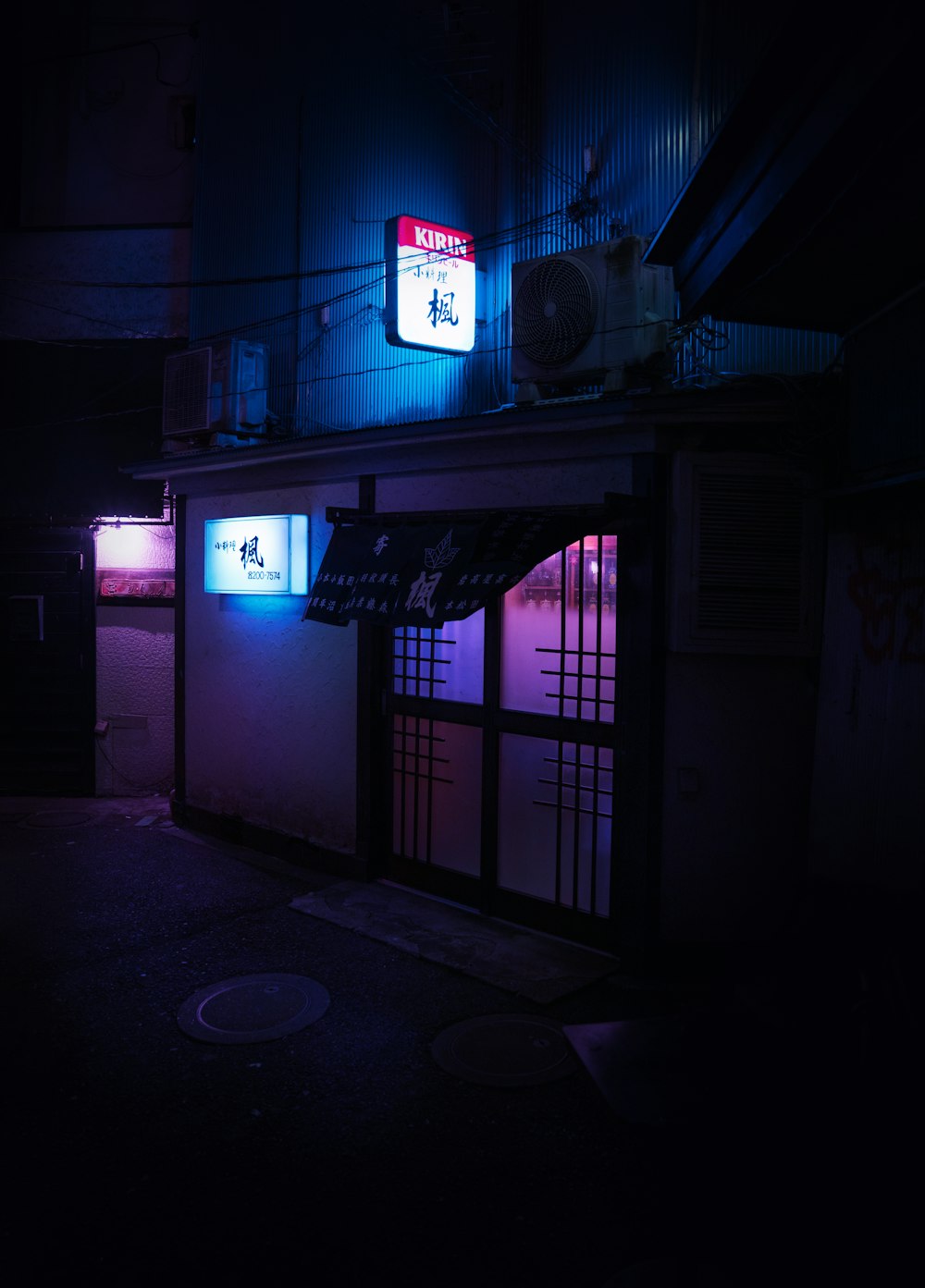 a building with a neon sign lit up at night