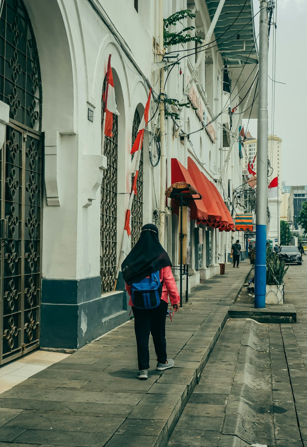a person walking down a street with a backpack