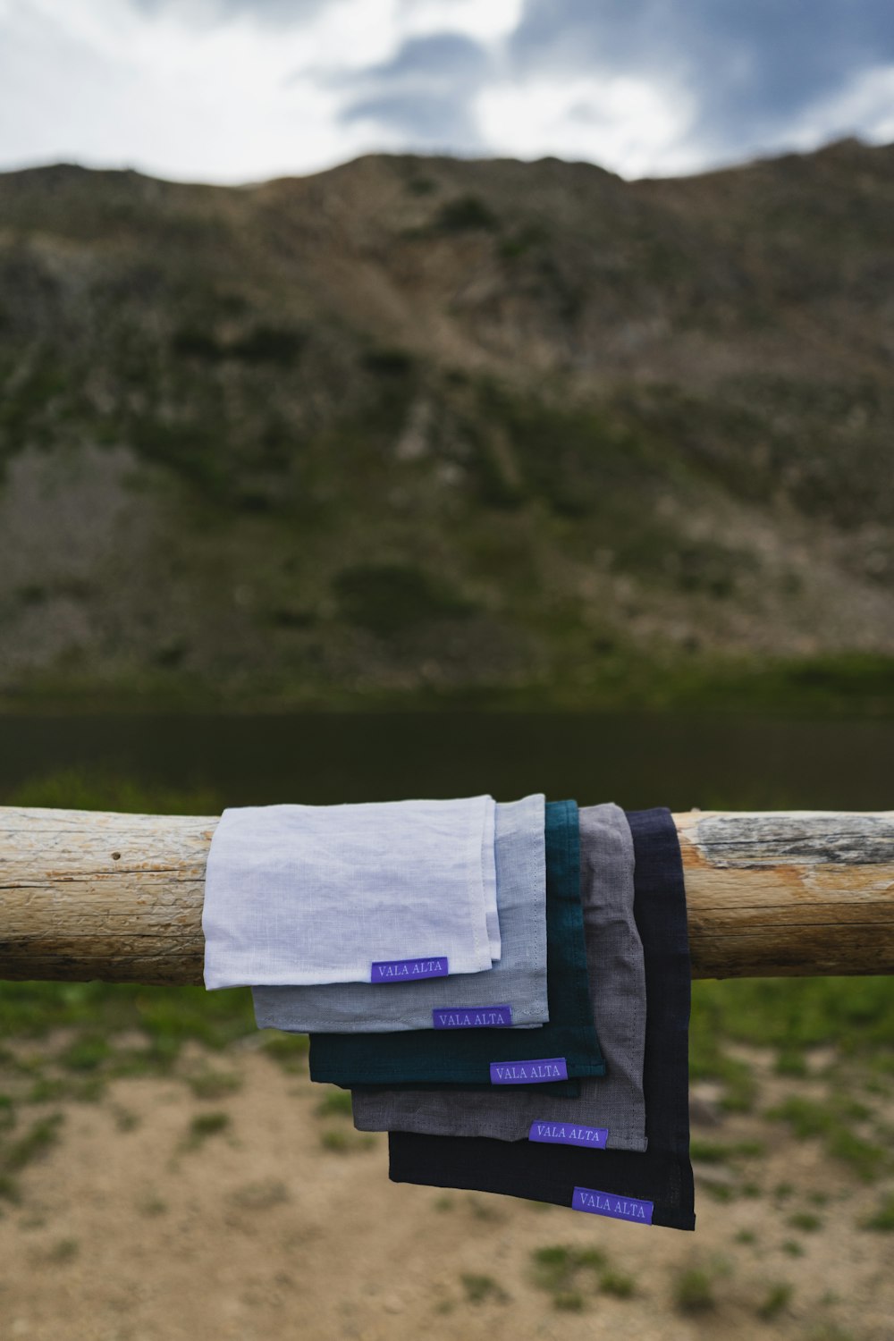 a bunch of towels hanging from a wooden pole