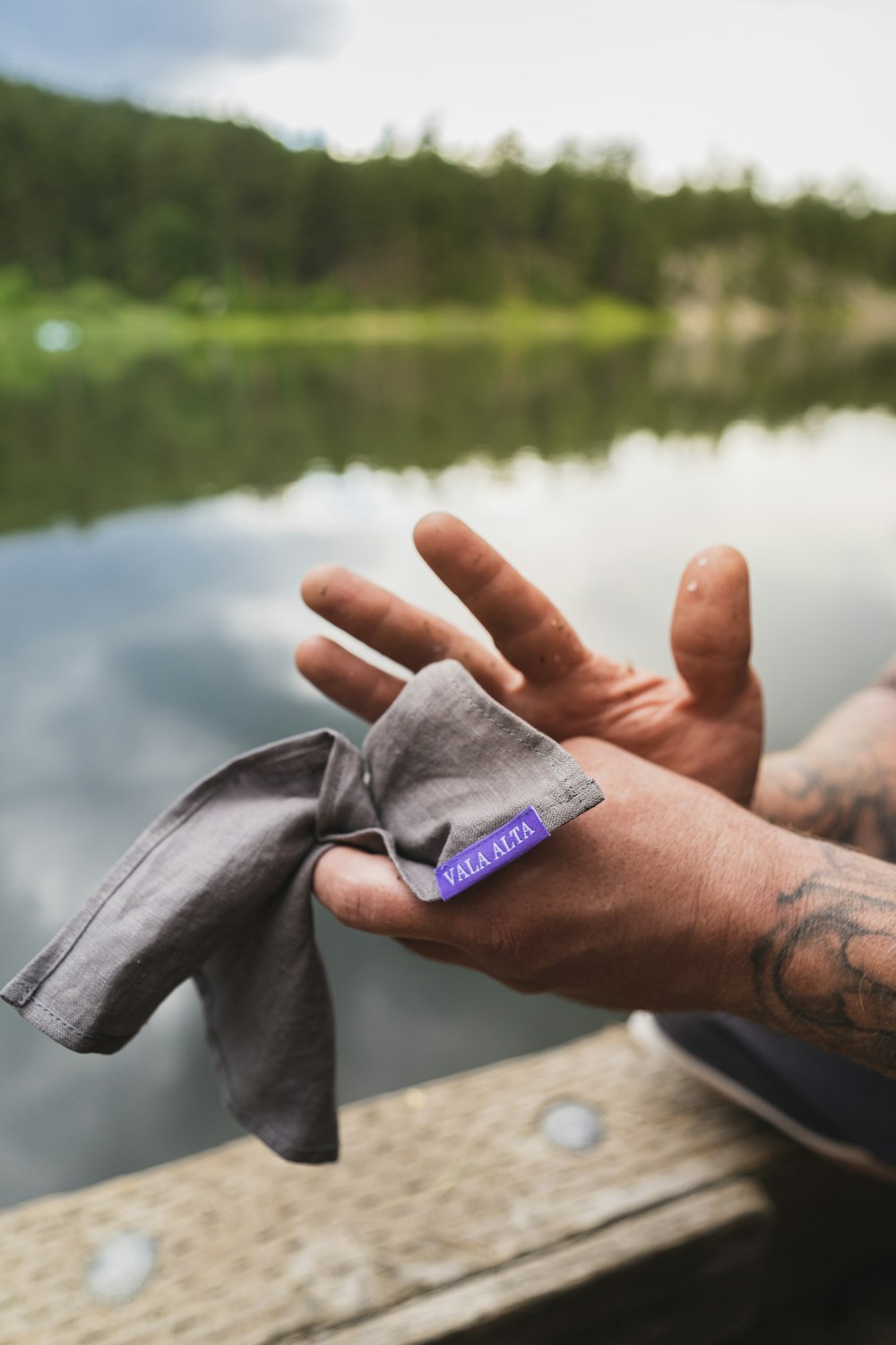 a man with a tattoo on his arm holding a napkin