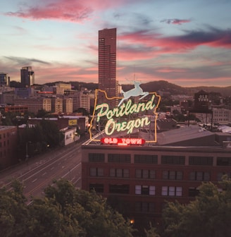 a large neon sign on top of a building