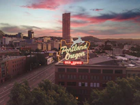 a large neon sign on top of a building