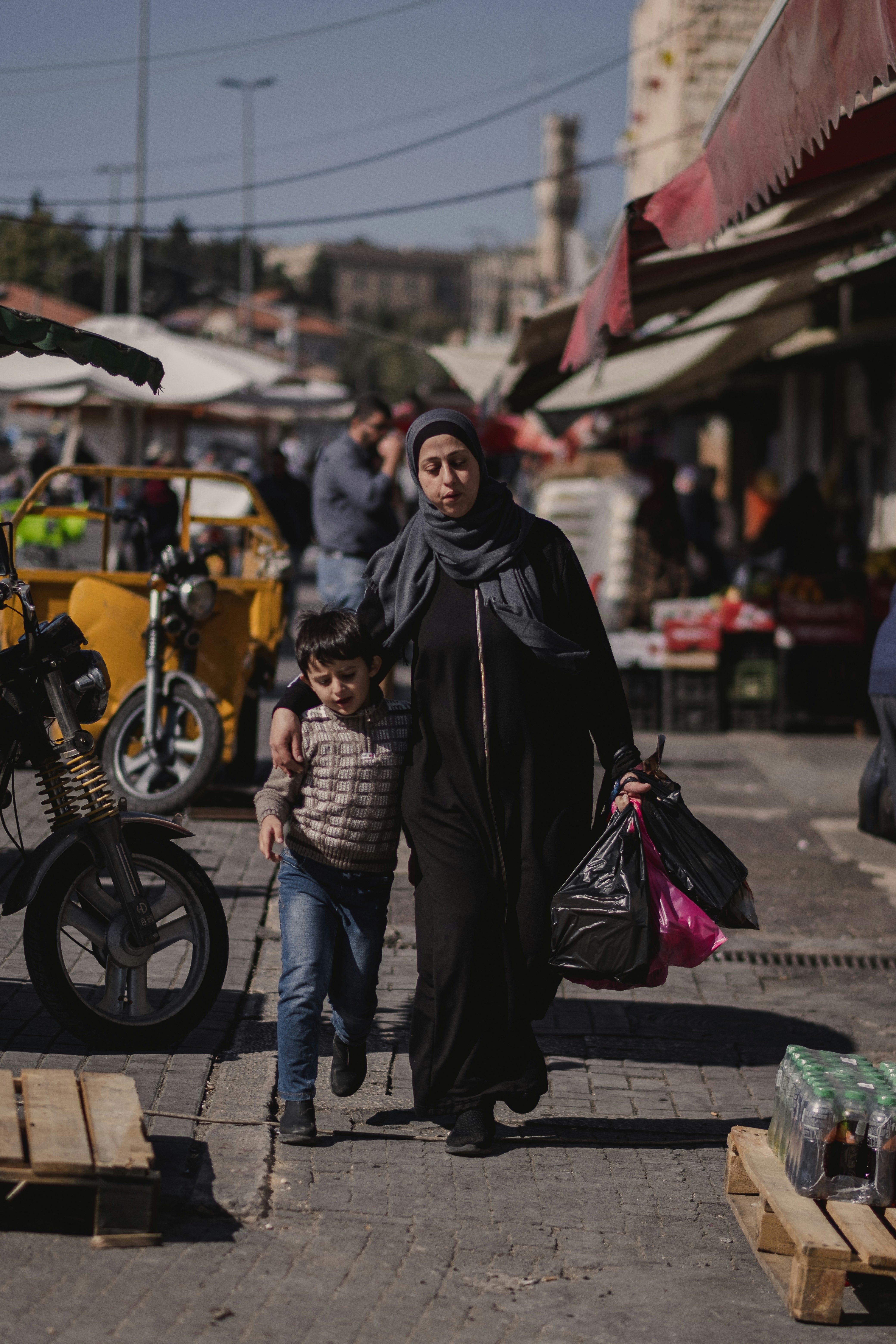 a woman and a child walking down a street