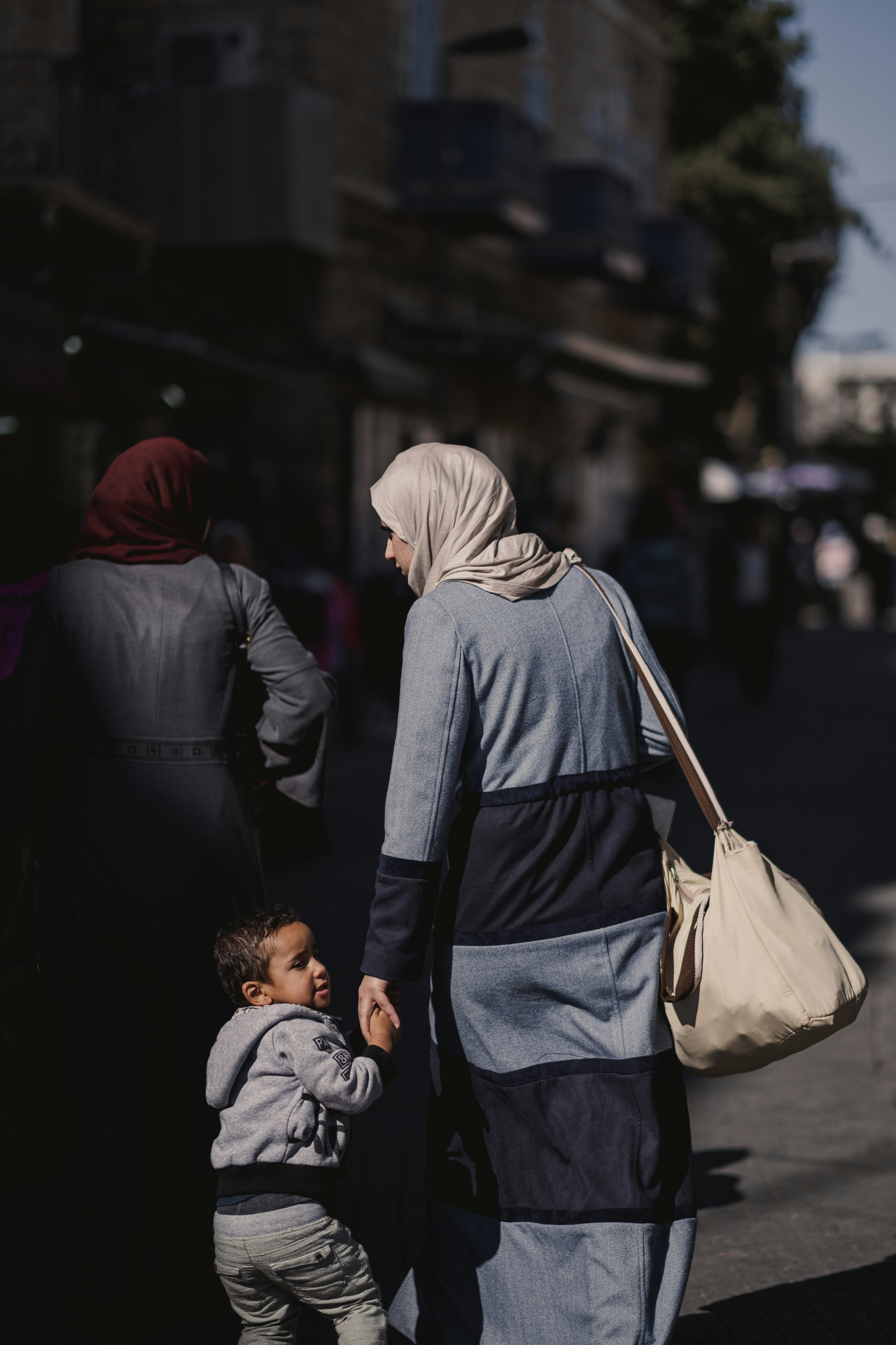 a woman and child walking down a street