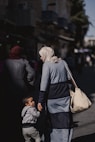 a woman and child walking down a street