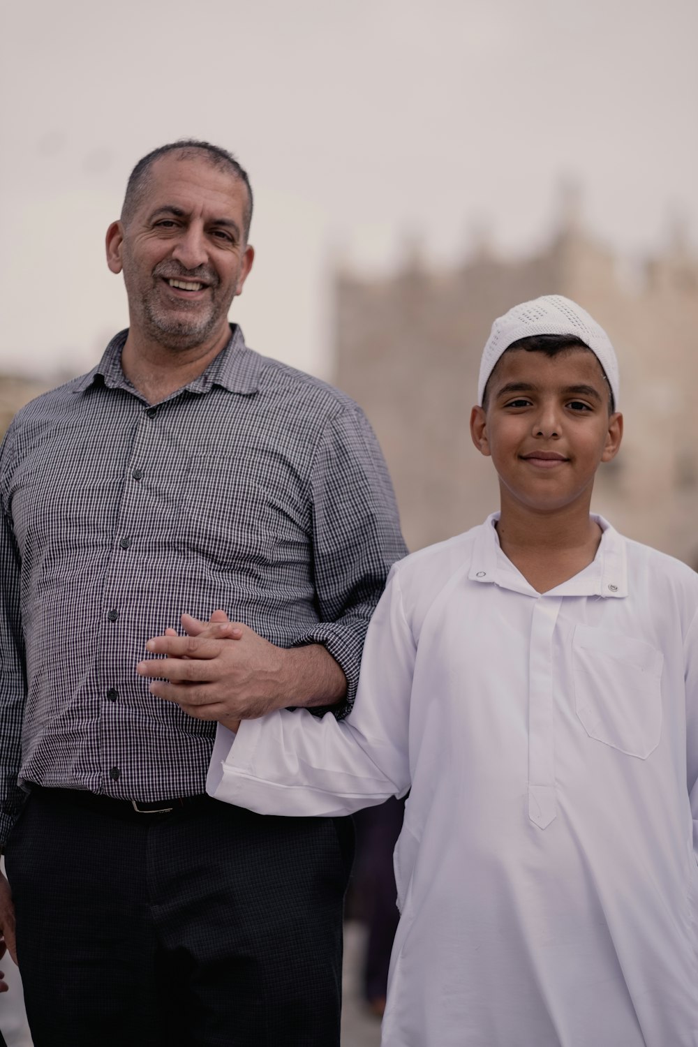 a man standing next to a little boy