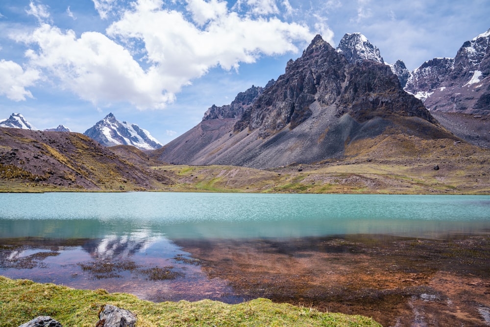 Ein von Bergen umgebener See unter blauem Himmel