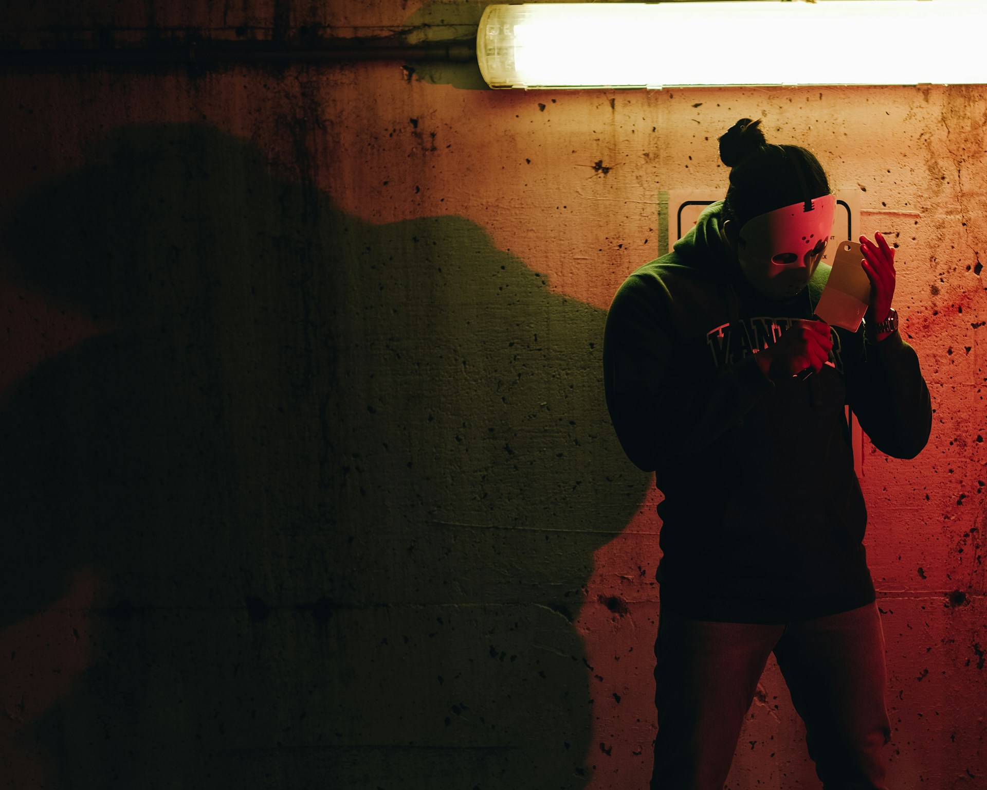 a man standing in front of a red light