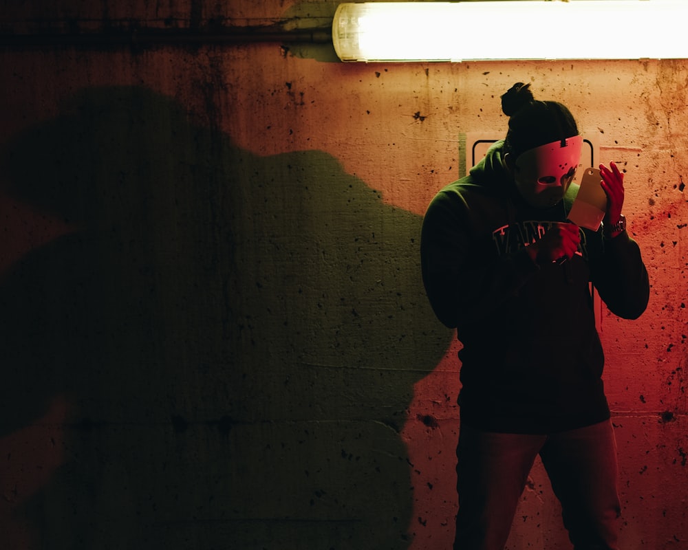 a man standing in front of a red light