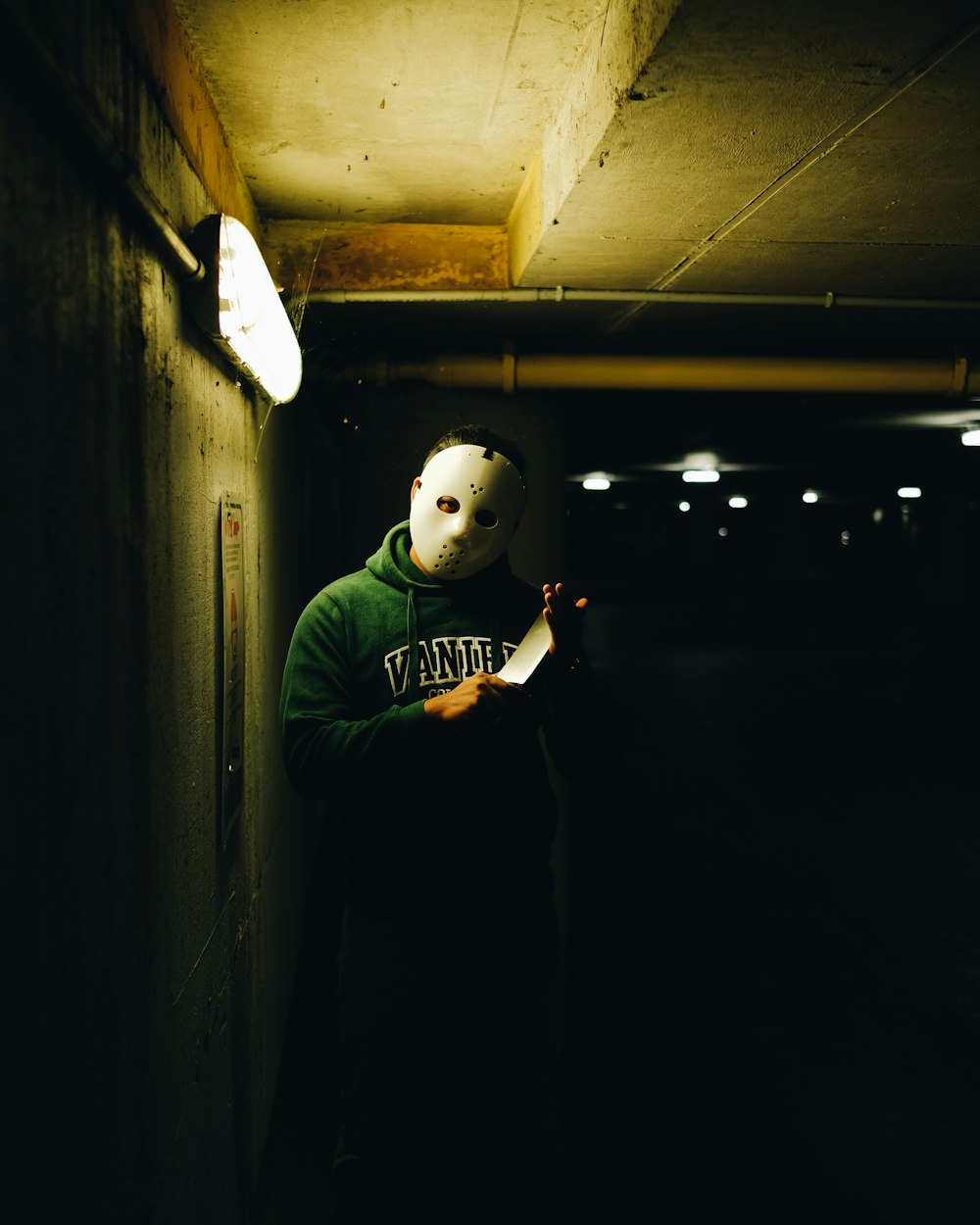 a person wearing a mask standing in a tunnel