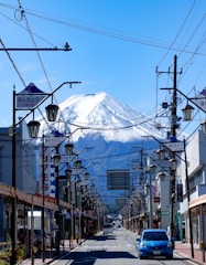 a car driving down a street with a mountain in the background