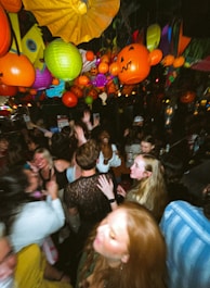 a group of people standing around each other at a party