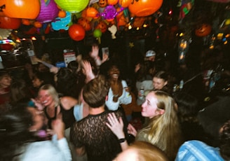 a group of people standing around each other at a party