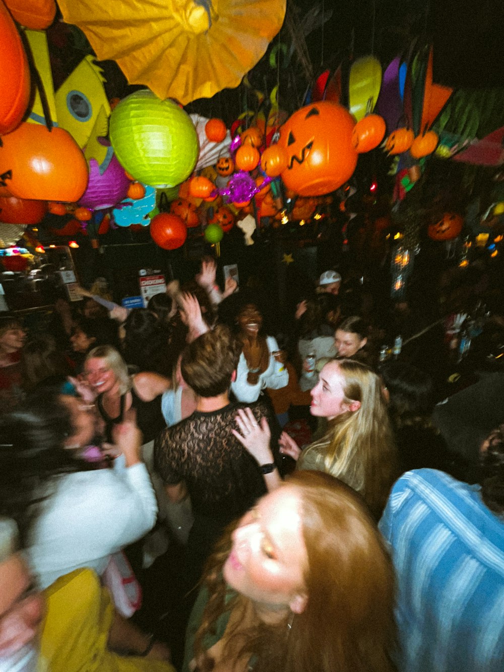 a group of people standing around each other at a party