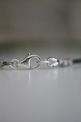 Close-up of a polished 925 silver lobster clasp highlighting CNC precision.