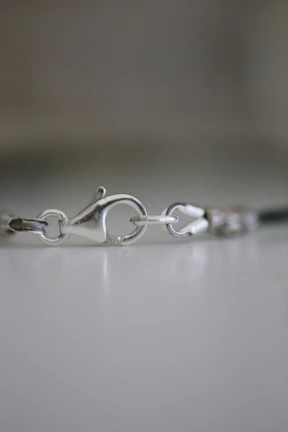 Macro shot highlighting the intricate stone setting and polish on a delicate necklace clasp.