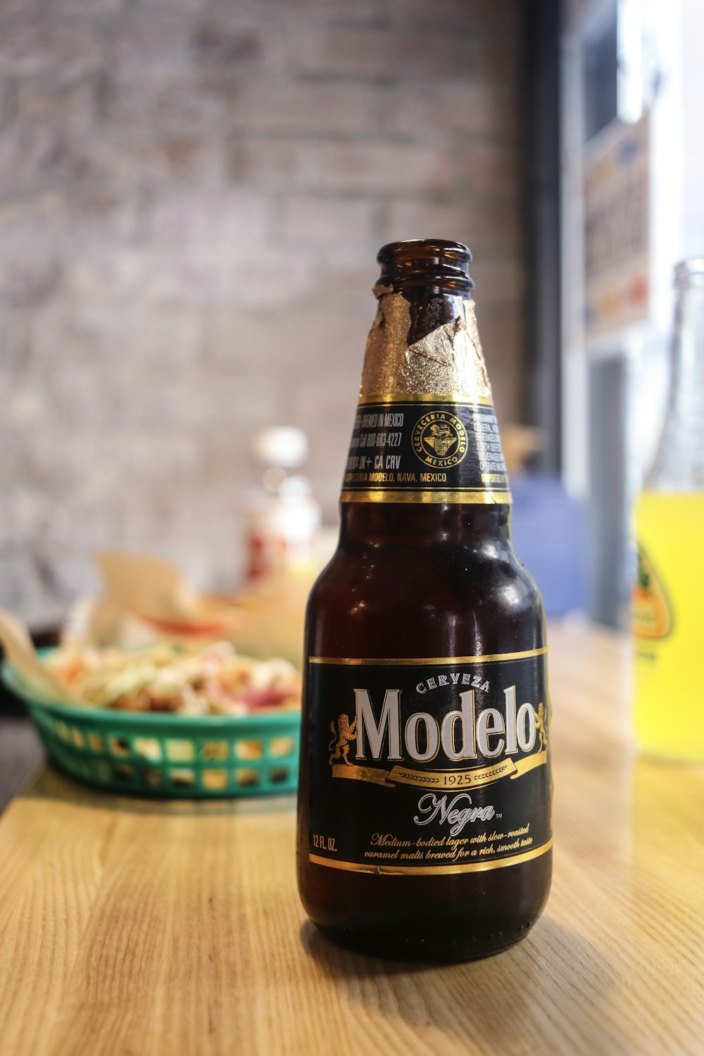 a bottle of modelo beer sitting on a table