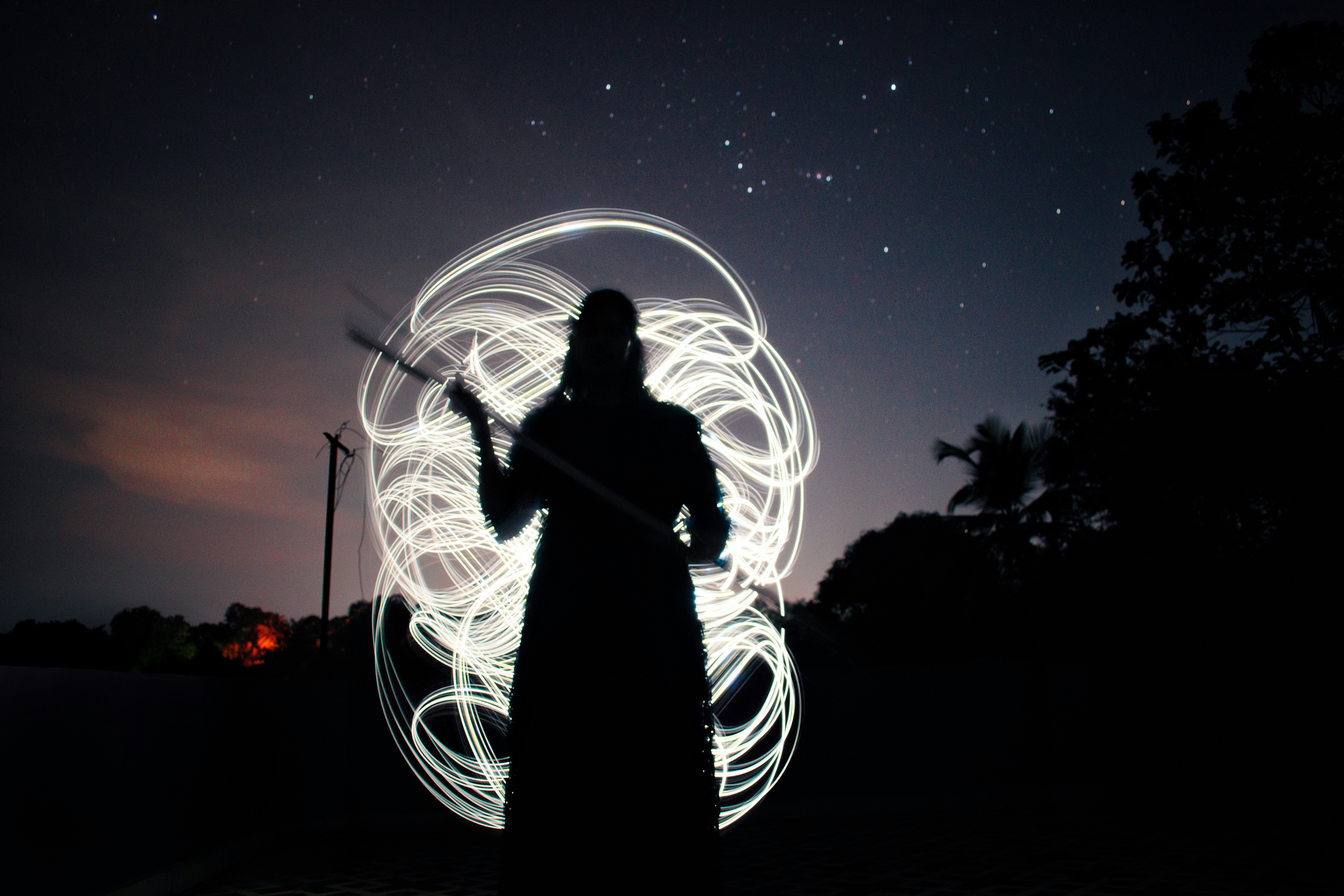 a person standing in the dark with a light painting