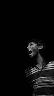 A black and white portrait of an actor mid-performance, full of emotion.