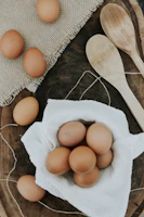 Fresh farm eggs and creamy butter arranged on a kitchen counter.