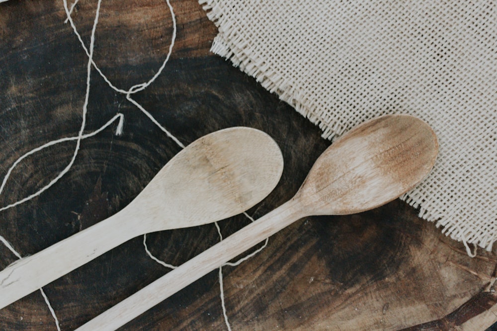 a couple of wooden spoons sitting on top of a table