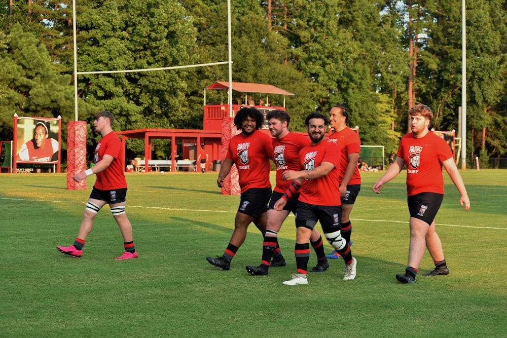 a group of young men standing on top of a soccer field