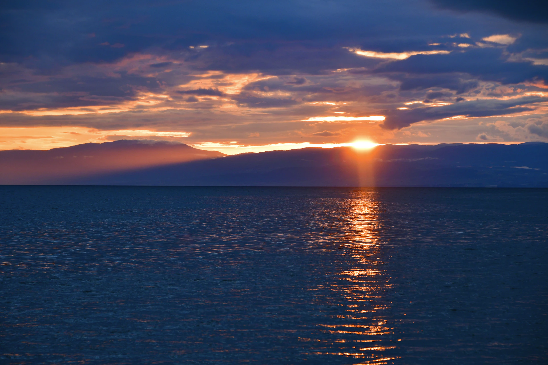 a large body of water under a cloudy sky