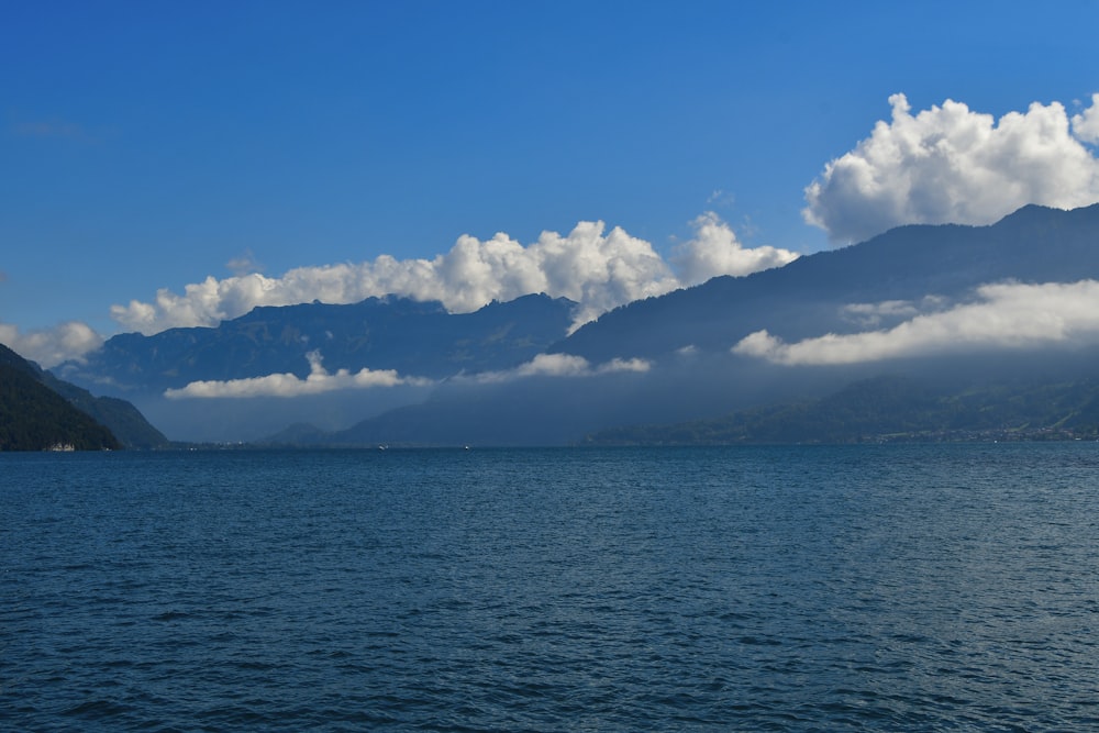 a body of water with mountains in the background