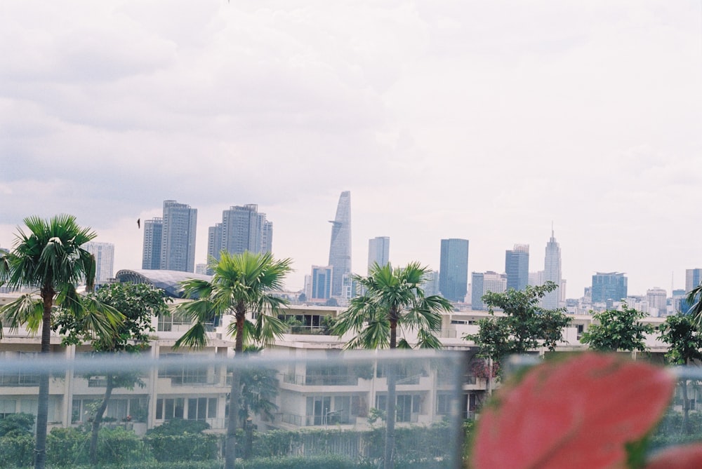 a view of a city from behind a fence