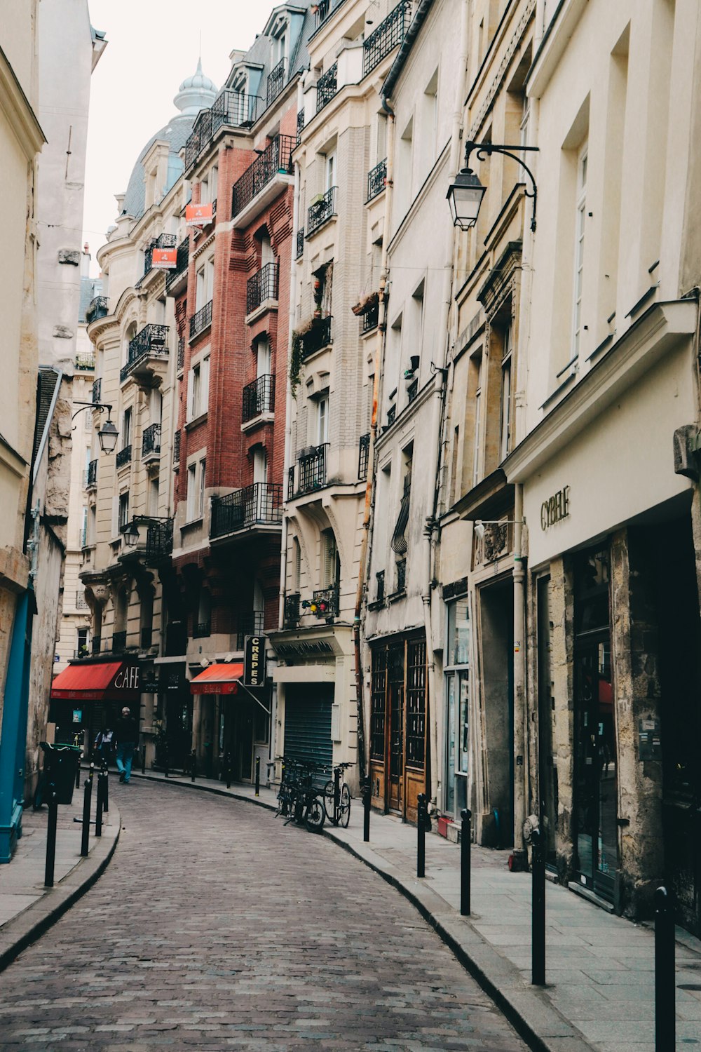 a city street lined with tall buildings next to each other