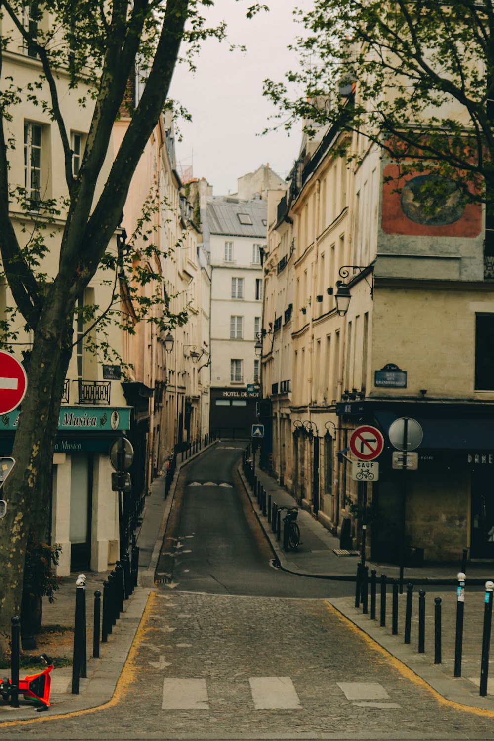 a narrow city street lined with tall buildings