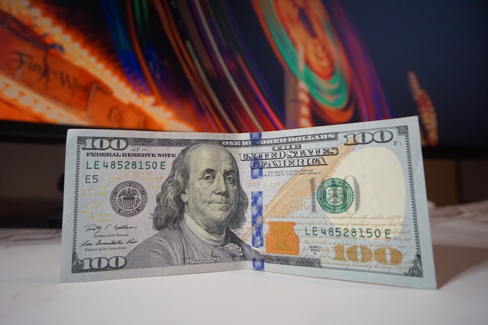 a one hundred dollar bill folded in half