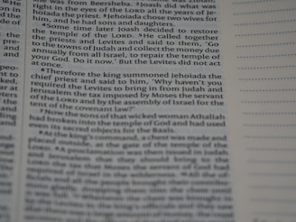 Text from a religious book with a passage discussing events involving a restoration of the temple, instructions from a king, priests, and Levites. The page appears to be in English and has a column of dotted lines on the right.