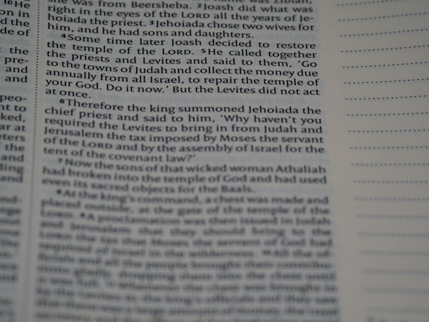 Text from a religious book with a passage discussing events involving a restoration of the temple, instructions from a king, priests, and Levites. The page appears to be in English and has a column of dotted lines on the right.