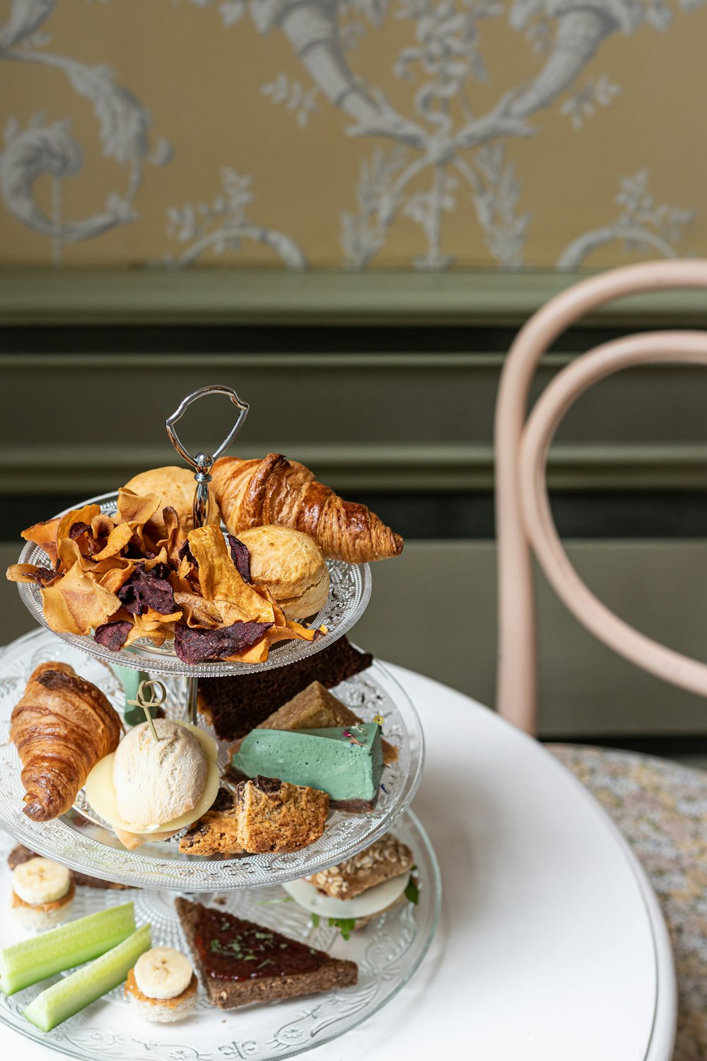 a three tiered tray of pastries on a table