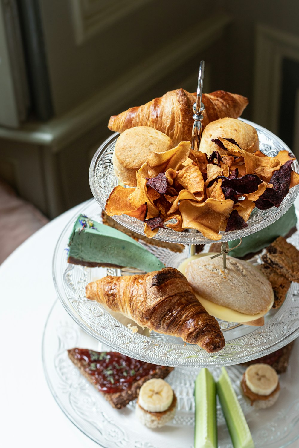 a three tiered platter of food on a table