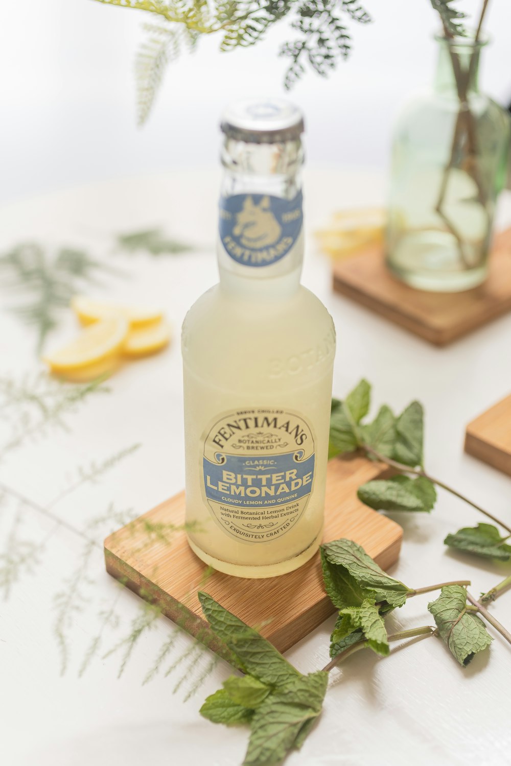 a bottle of lemonade sitting on top of a cutting board