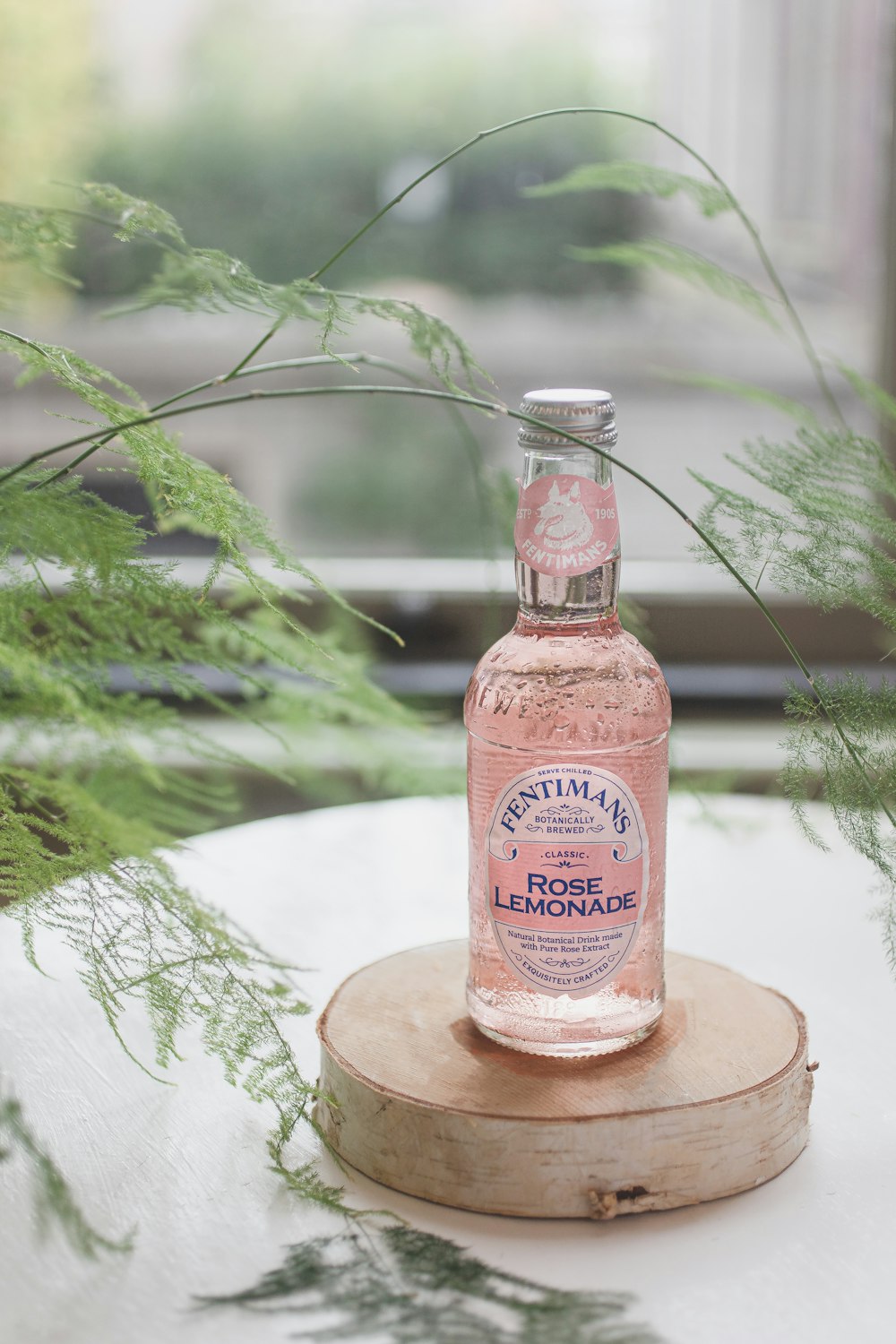 a bottle of rose lemonade sitting on top of a table