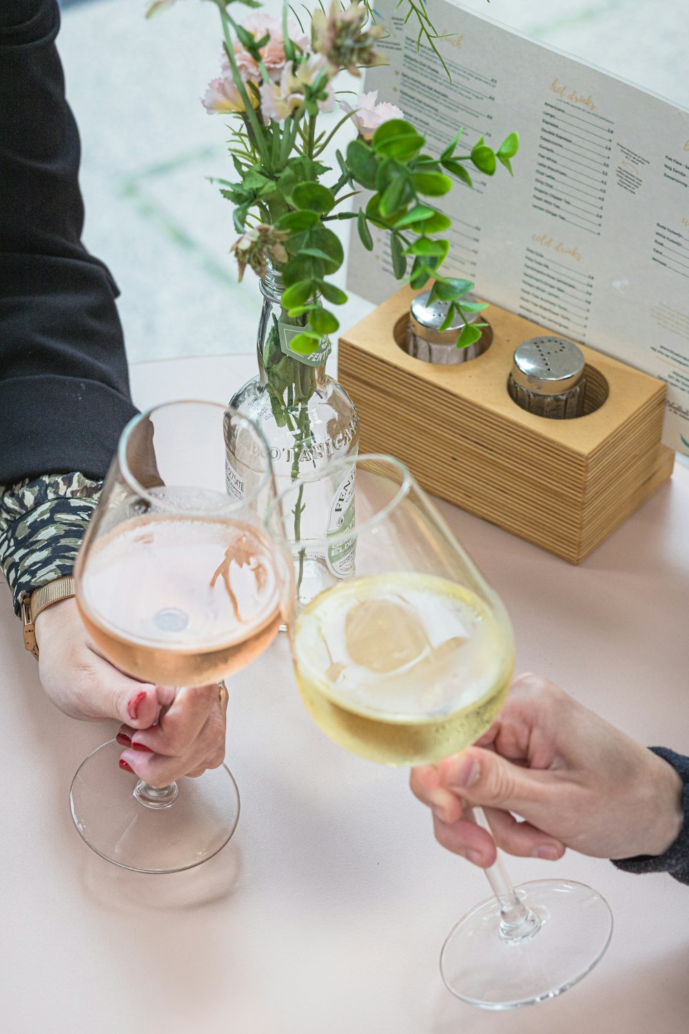 a couple of people holding glasses of wine