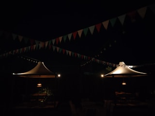 A nighttime view of a cultural festival space illuminated with subtle accent lighting.