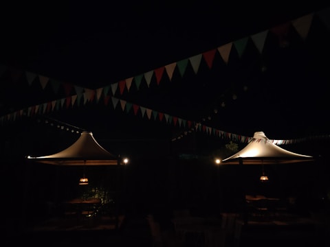 A nighttime view of a cultural festival space illuminated with subtle accent lighting.