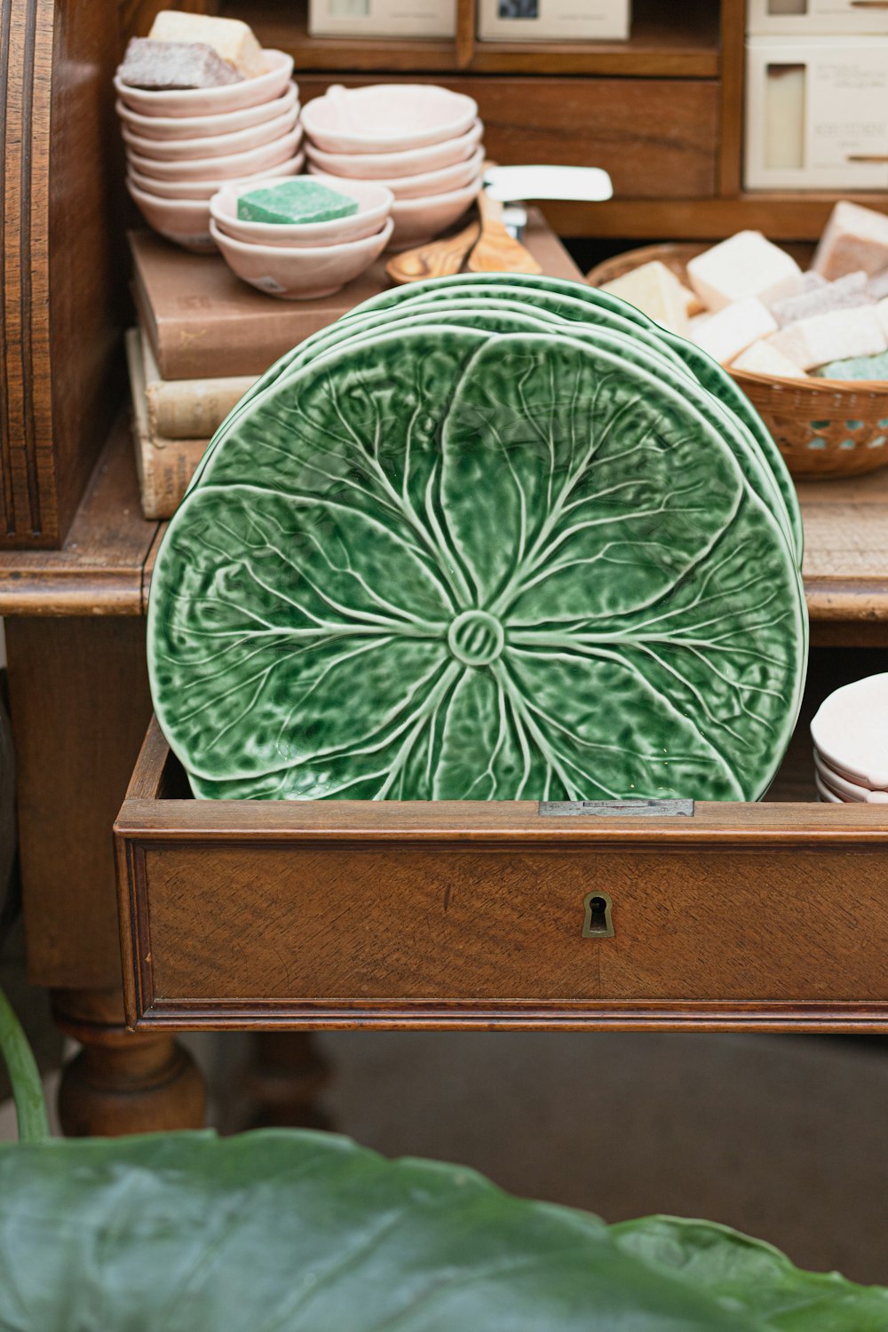 a green plate sitting on top of a wooden table