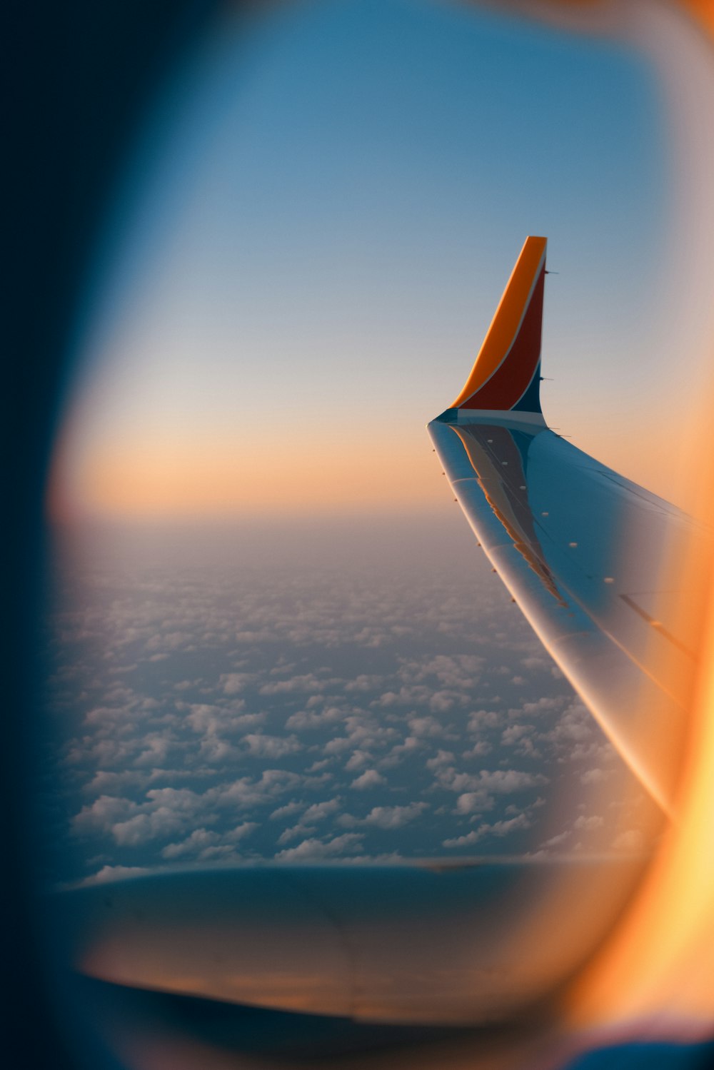 a view of the wing of an airplane in the sky