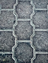 Close-up of colorful interlocking paving stones neatly stacked outdoors.