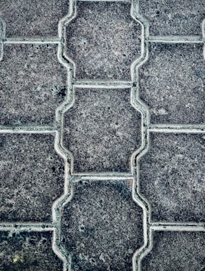 Close-up of freshly laid interlock paving with precise patterns in a residential driveway.