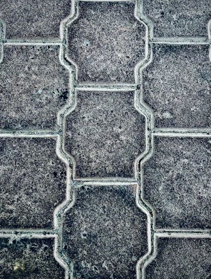 Close-up of colorful paver blocks neatly arranged in a pattern.
