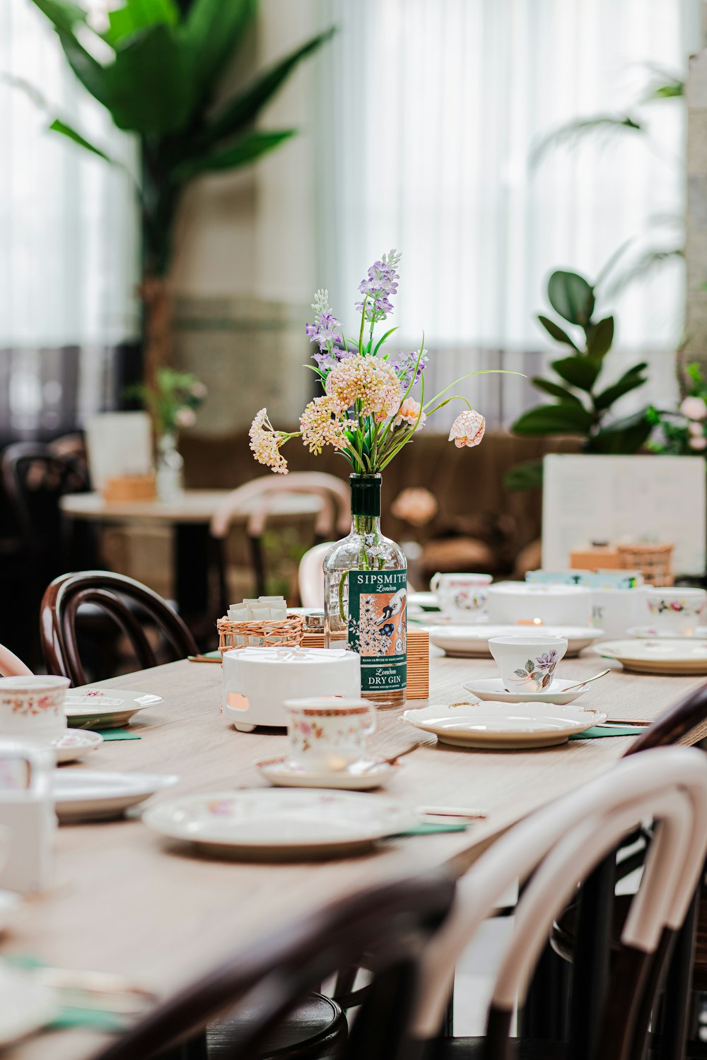 a table with a vase of flowers on top of it