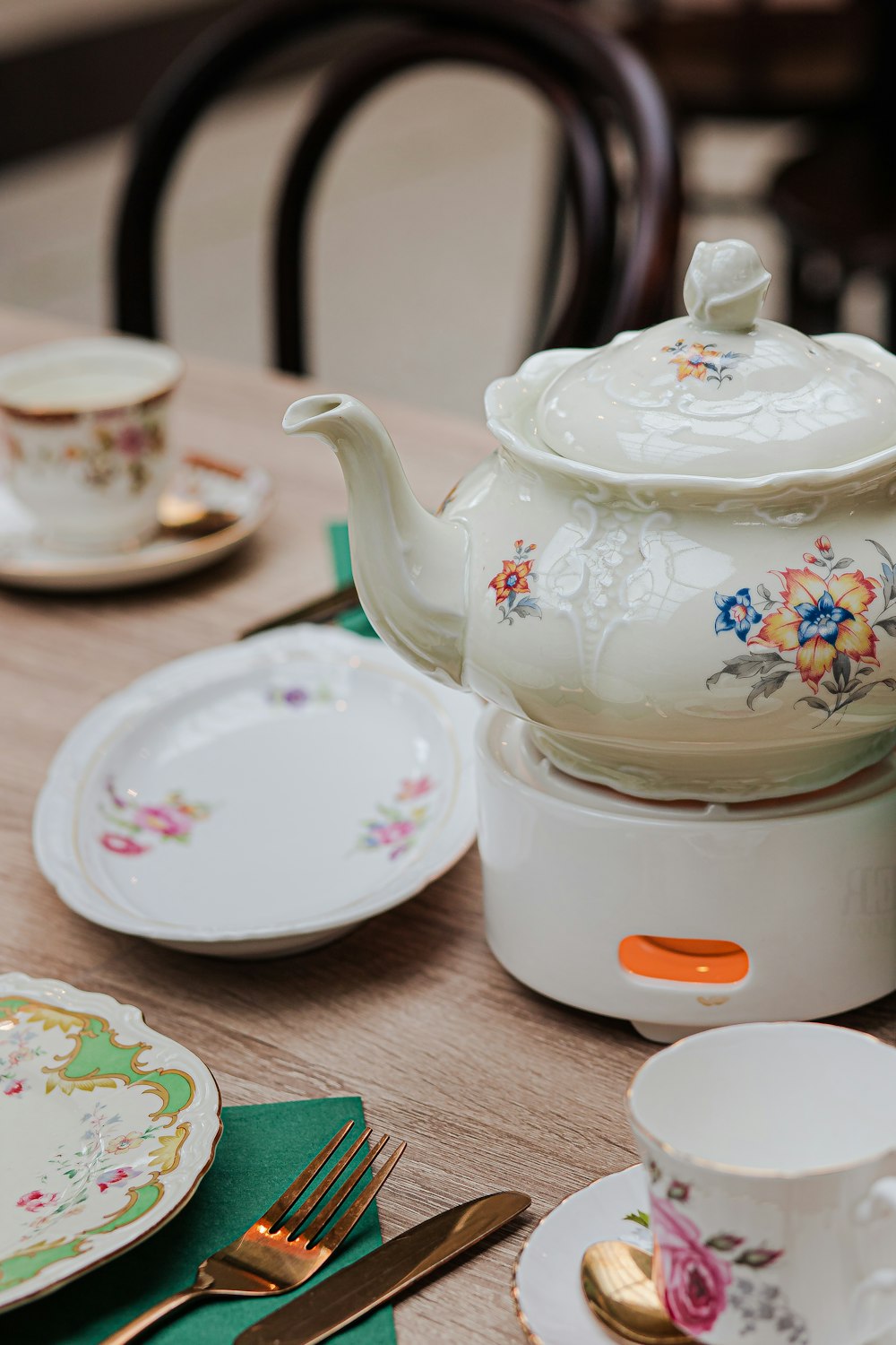 a tea pot sitting on top of a wooden table