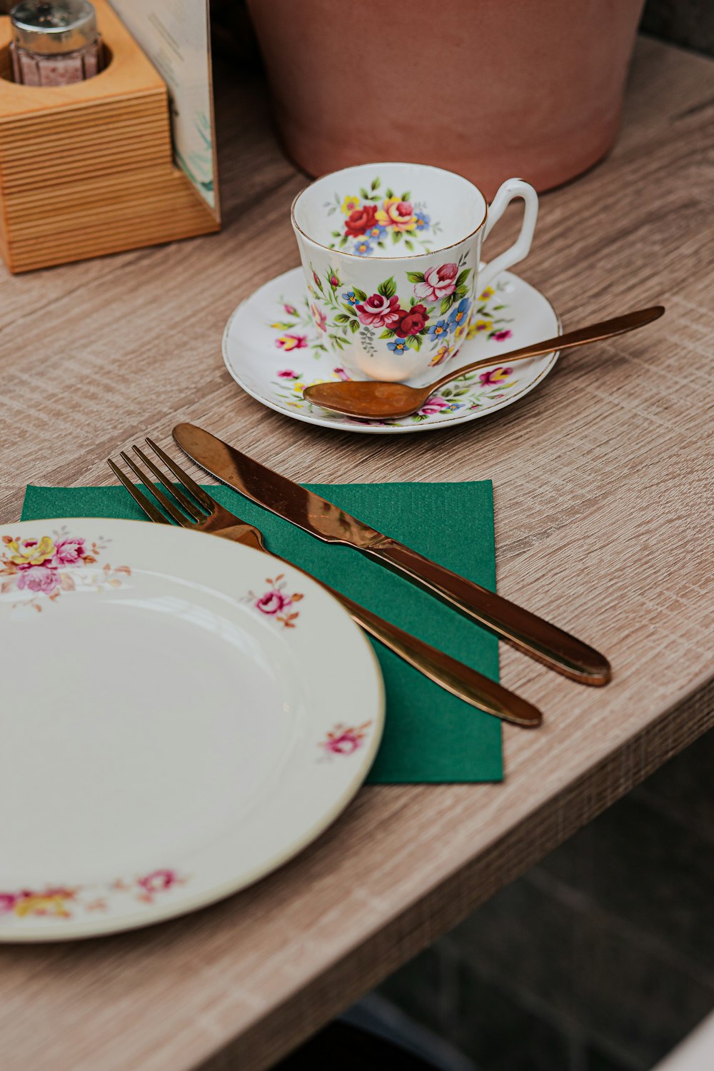 a table topped with a plate and a cup